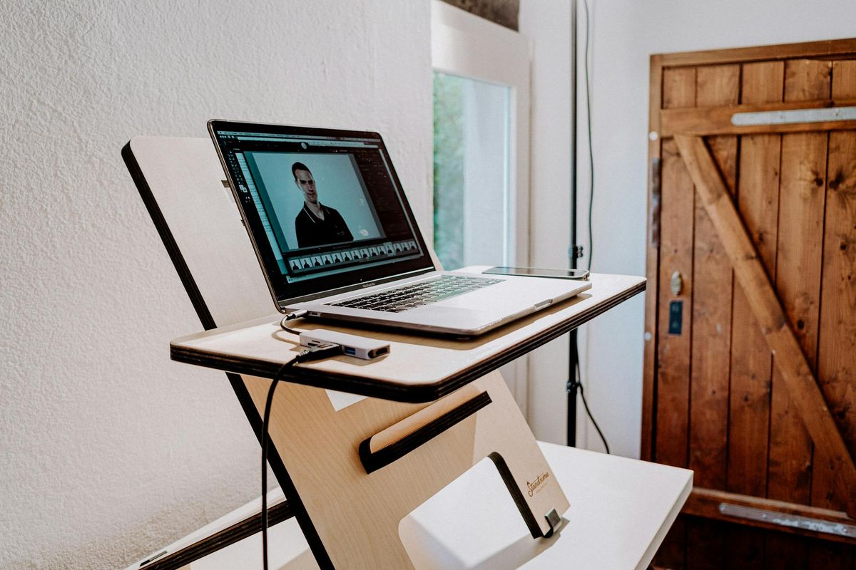 Organized minimalist workspace with wooden desk and natural light.